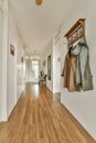 a long hallway with a coat rack on the wall