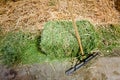 Long handled scrub brush with small square hay bale Royalty Free Stock Photo