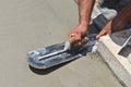 Troweling fresh concrete on a garage foundation with a trowel left  on the surface Royalty Free Stock Photo