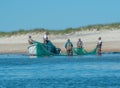 Long haul net crew pulling the nets back on the boat at the end of the day