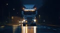 Long Haul Semi-Truck with Cargo Trailer Full of Goods Travels At Night on the Freeway Road, Driving Across Continent Royalty Free Stock Photo