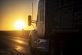 Long Haul 18 Wheel Truck driving on a highway at sunrise or sunset Royalty Free Stock Photo