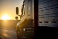 Long Haul 18 Wheel Truck driving on a highway at sunrise or sunset Royalty Free Stock Photo