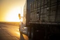 Long Haul 18 Wheel Truck driving on a highway at sunrise or sunset Royalty Free Stock Photo