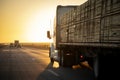 Long Haul 18 Wheel Truck driving on a highway at sunrise or sunset Royalty Free Stock Photo