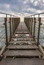 Long high and narrow steel stairs over high building with sky over it Royalty Free Stock Photo
