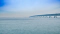 A long highway bridge across sea with blue sky background Royalty Free Stock Photo