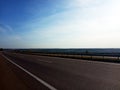 Long highway under the blue sky