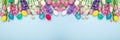 Long horizontal banner with easter eggs, hyacinths and tulips on blue background. Easter concept. Copy space