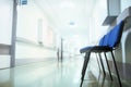 Long hospital hallway with vacant chairs