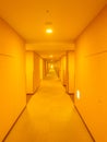 Long hotel corridor with warm light