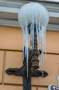 Long icicles adorn the street lamp. Winter