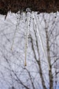 Spring icicles on the roof against cloudy sky Royalty Free Stock Photo