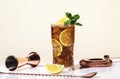 Long Island ice tea cocktail with vodka, rum, tequila, gin, liquor, lemon juice, cola and ice, garnished with lemon slice and mint Royalty Free Stock Photo