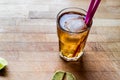 Long island iced tea cocktail with lime, ice and served with pink straw Royalty Free Stock Photo