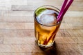 Long island iced tea cocktail with lime, ice and served with pink straw Royalty Free Stock Photo