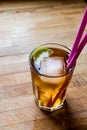 Long island iced tea cocktail with lime, ice and served with pink straw Royalty Free Stock Photo