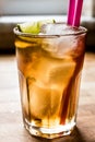 Long island iced tea cocktail with lime, ice and served with pink straw Royalty Free Stock Photo