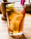 Long island iced tea cocktail with lime, ice and served with pink straw Royalty Free Stock Photo