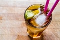 Long island iced tea cocktail with lime, ice and served with pink straw Royalty Free Stock Photo