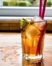 Long island iced tea cocktail with lime, ice and served with pink straw Royalty Free Stock Photo