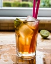 Long island iced tea cocktail with lime, ice and served with pink straw Royalty Free Stock Photo