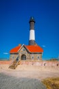 LONG ISLAND, USA, APRIL, 14, 2018: The Montauk Lighthouse at the easternmost point of Long Island with a house building