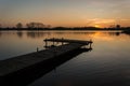 Long jetty on a calm lake and the sky during sunset Royalty Free Stock Photo