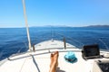 Long legs of a young woman on a yacht in the open sea having a rest start to travel with pleasure relax summer holidays