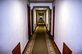 Long lighted corridor with many doors and carpeted floor Royalty Free Stock Photo