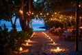 A long line of candles illuminate a beach, creating a captivating sight, A candlelit pathway leading to a beautifully decorated