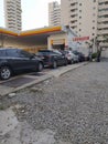 Long line of cars in front of a shell gas station waiting for washing services. Royalty Free Stock Photo