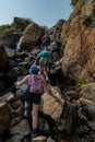 Long Line of Hikers Ascending Rocks toward Sky Pond Royalty Free Stock Photo