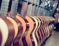 Long line of new acoustic guitars in store Royalty Free Stock Photo