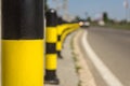 Long line of yellow and black traffic signs to deter the cars around the road