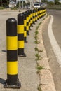 Long line of yellow and black traffic signs to deter the cars around the road
