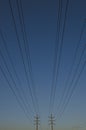 The long lines of the power poles in the dusty blue sky. Royalty Free Stock Photo