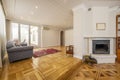 Long living room with two heights, wonderful wooden floors with inlaid wood, several upholstered sofas and a fireplace with a Royalty Free Stock Photo