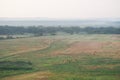 A long, lonely road through the morning misty field Royalty Free Stock Photo