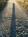Long-long human shadow at sunset