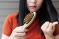 Long loss hair on woman brush with and woman looking at her hair Royalty Free Stock Photo