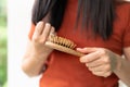 Long loss hair on woman brush with and woman looking at her hair Royalty Free Stock Photo