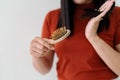 Long loss hair on woman brush with and woman looking at her hair Royalty Free Stock Photo