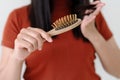 Long loss hair on woman brush with and woman looking at her hair Royalty Free Stock Photo