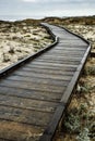 Wooden walkway over sand to ocean shore Royalty Free Stock Photo