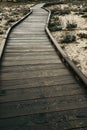 Wooden walkway over sand to shore Royalty Free Stock Photo