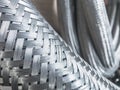 Long metal flexible compensator pipes metal texture Royalty Free Stock Photo
