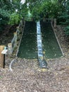 Long metal slide on hillside at park