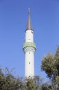 The long minaret of the eastern Muslim mosque with a crescent moon against the blue sky Royalty Free Stock Photo