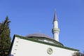 The long minaret of the eastern Muslim mosque with a crescent moon against the blue sky Royalty Free Stock Photo